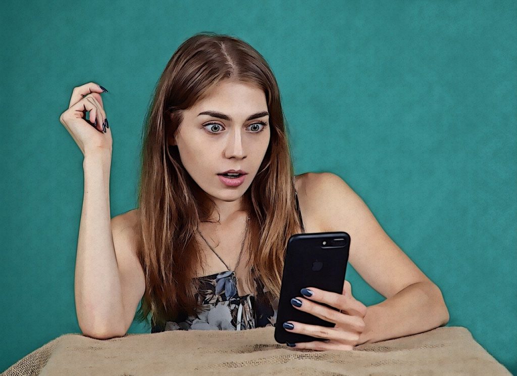 Shocked Woman Reading Phone